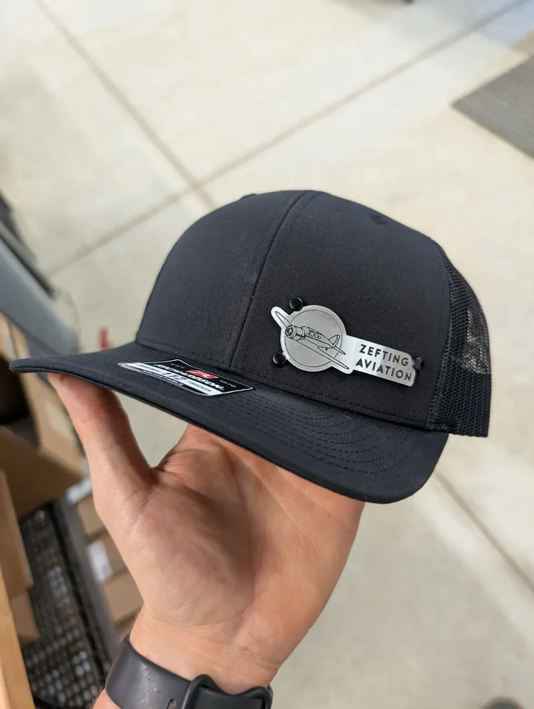 Custom Company Badge Hats With Logo - Mesh Trucker Hat – Brushed Silver/Black Badge - Economy - Headgear Hats