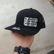 Custom Company Badge Hats With Logo - Mesh Trucker Hat – Brushed Silver/Black Badge - Economy - Headgear Hats