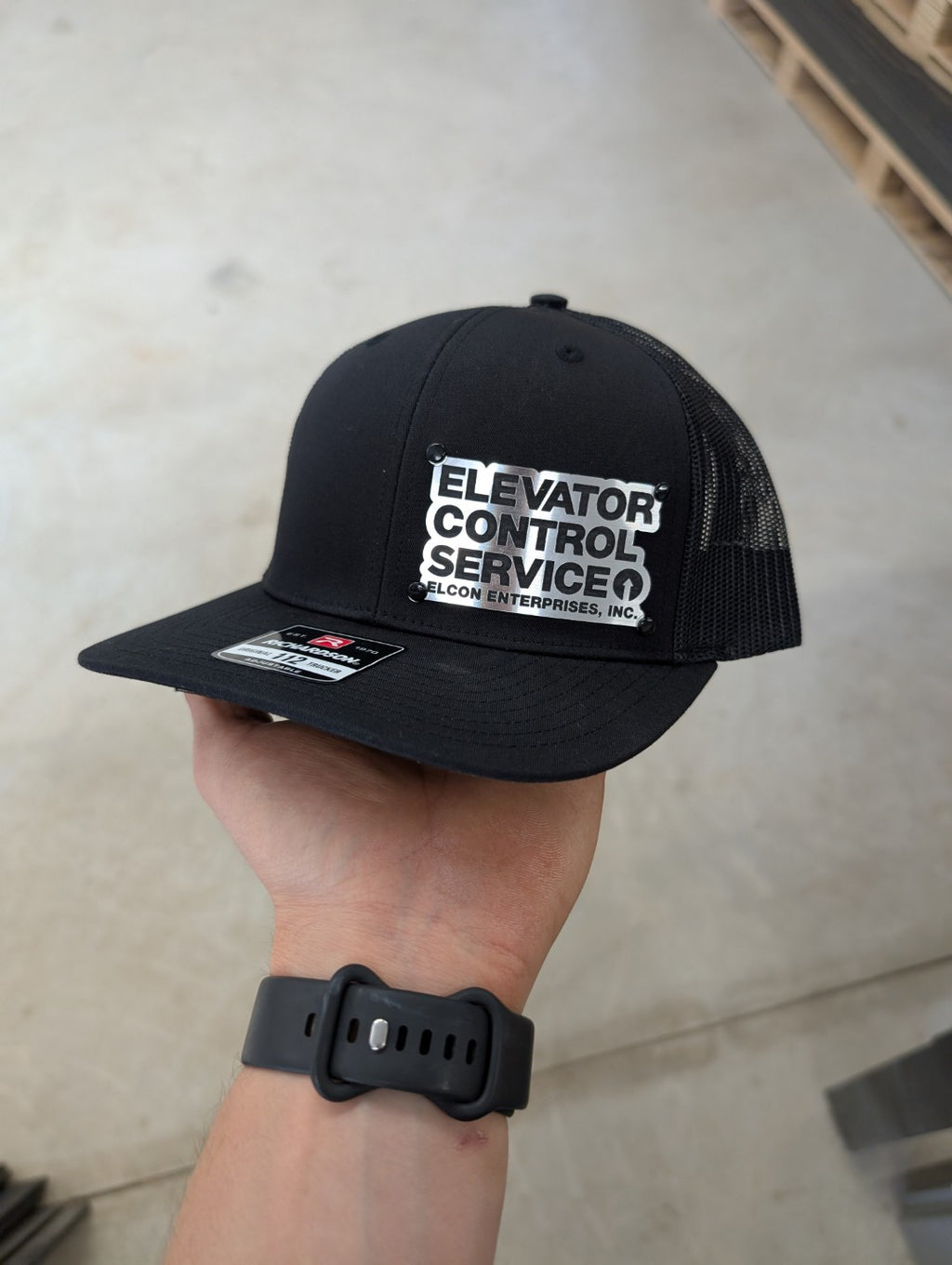 Custom Company Badge Hats With Logo - Mesh Trucker Hat – Brushed Silver/Black Badge - Economy - Headgear Hats